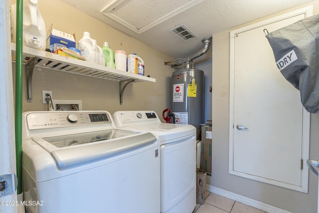laundry room featuring laundry area, light tile patterned floors, visible vents, independent washer and dryer, and water heater