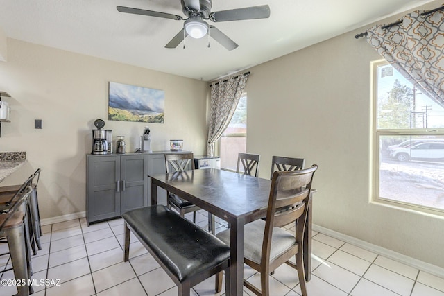 dining room with baseboards, a ceiling fan, and light tile patterned flooring