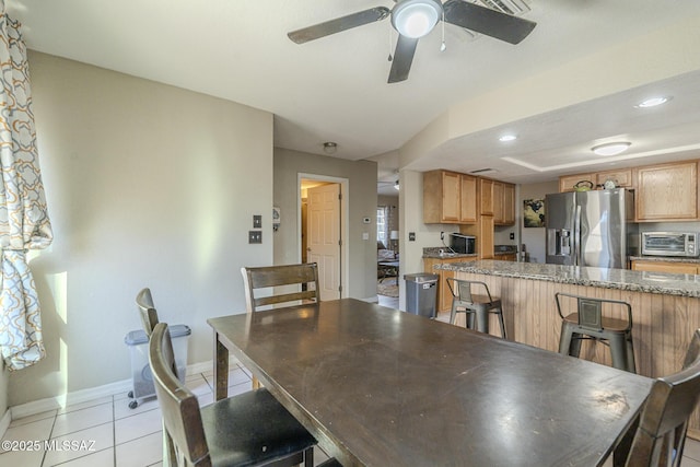 dining space featuring light tile patterned floors, a toaster, baseboards, a ceiling fan, and recessed lighting