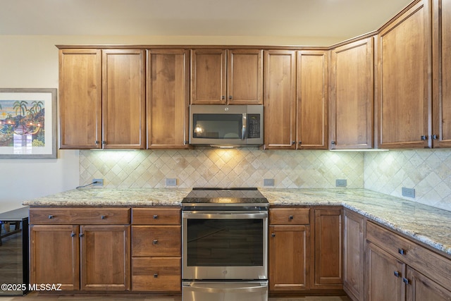 kitchen featuring light stone countertops, appliances with stainless steel finishes, beverage cooler, and backsplash