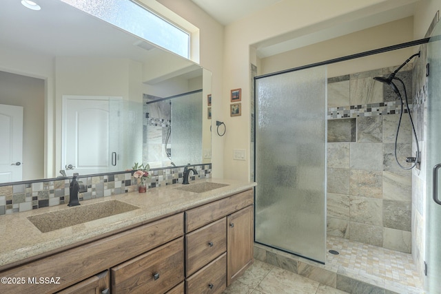 bathroom with walk in shower, vanity, and backsplash