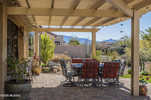 view of patio / terrace with a mountain view and a pergola