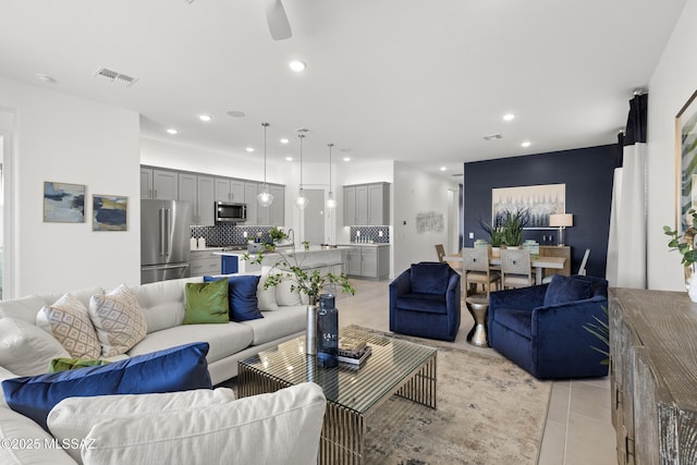 living room with ceiling fan and light tile patterned floors