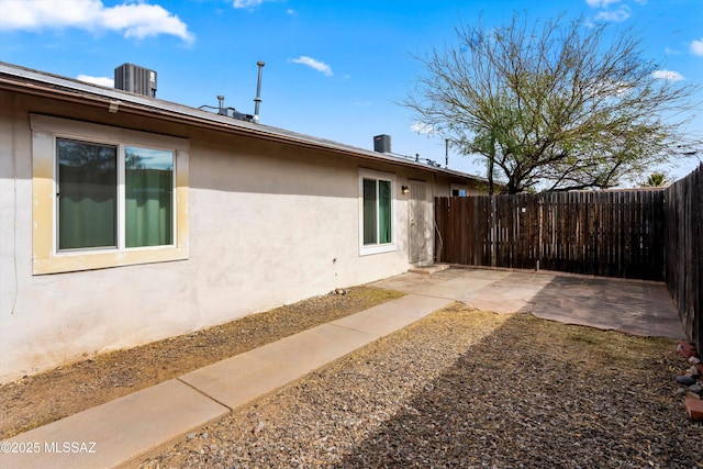 exterior space with cooling unit and a patio area