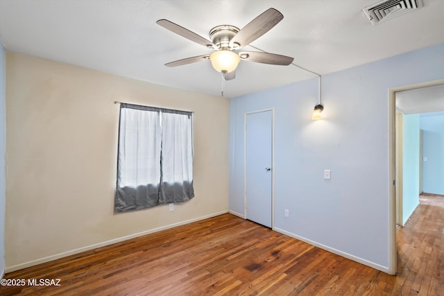 interior space featuring ceiling fan and dark hardwood / wood-style flooring