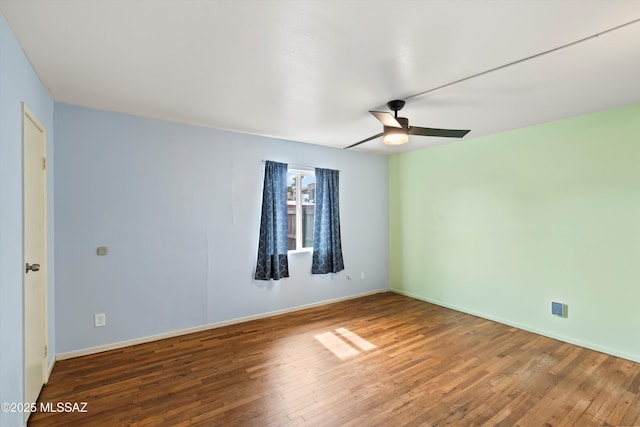 spare room with hardwood / wood-style flooring and ceiling fan