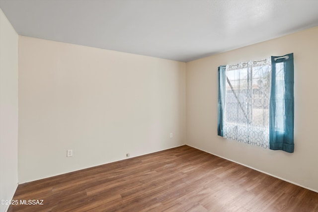 empty room with wood-type flooring