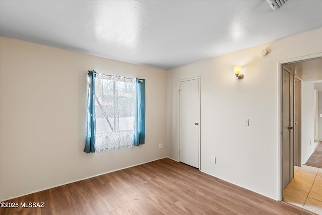 unfurnished room featuring light wood-type flooring