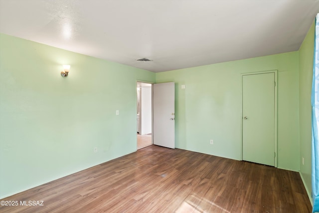 unfurnished bedroom featuring hardwood / wood-style flooring