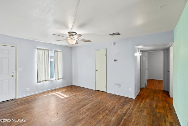 unfurnished bedroom featuring dark wood-type flooring and ceiling fan