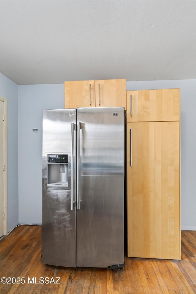 kitchen with dark hardwood / wood-style flooring, light brown cabinetry, and stainless steel fridge with ice dispenser