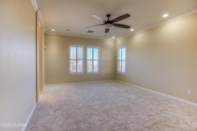 unfurnished room featuring ceiling fan, light colored carpet, and crown molding