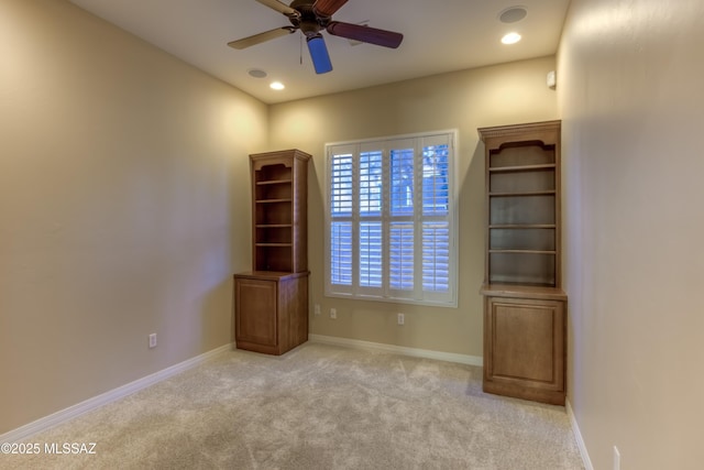 carpeted empty room featuring ceiling fan