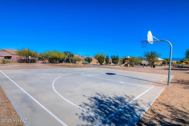 view of basketball court with a playground