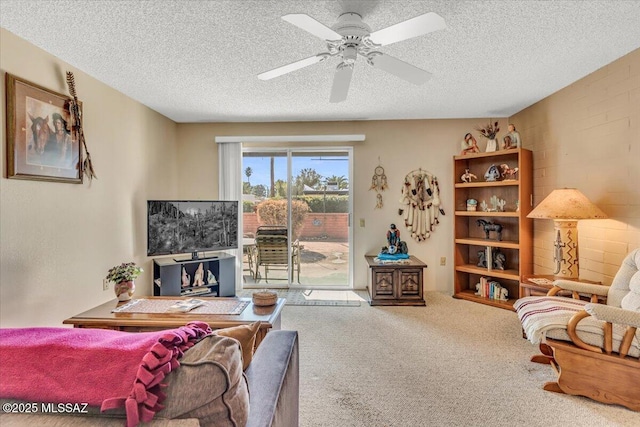 carpeted living room with ceiling fan and a textured ceiling