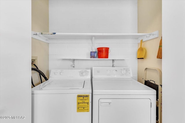 clothes washing area featuring washer and dryer