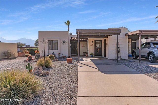 adobe home featuring a carport and a mountain view