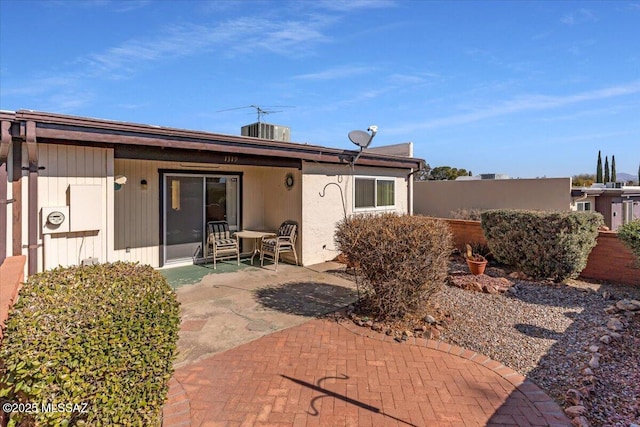 rear view of property with central AC and a patio