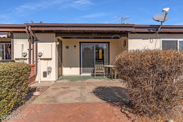 entrance to property with a patio