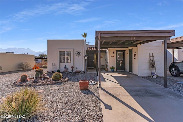 view of front of home with a carport and a mountain view