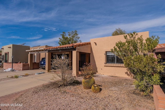 adobe home featuring a carport