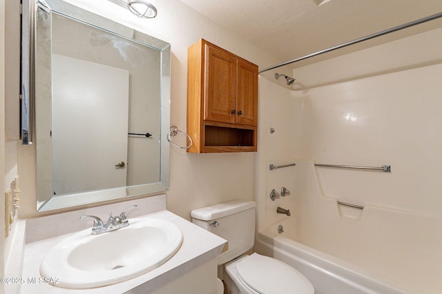 full bathroom with vanity, toilet, shower / washtub combination, and a textured ceiling