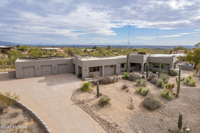 southwest-style home with a garage and a mountain view