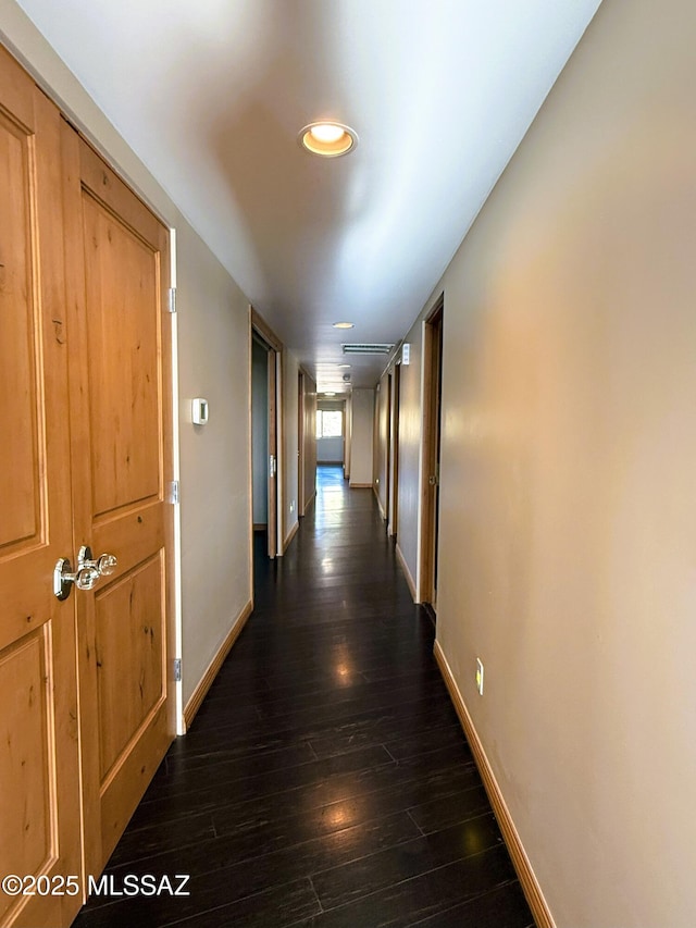 corridor with dark wood-type flooring