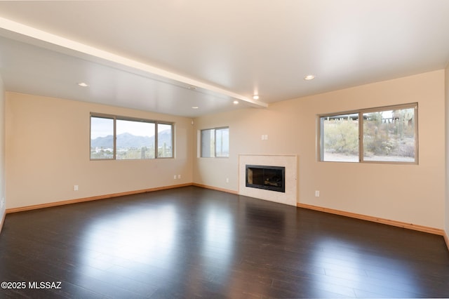 unfurnished living room with dark wood-type flooring and beamed ceiling