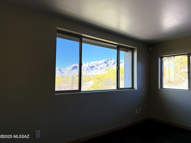 unfurnished room with a mountain view