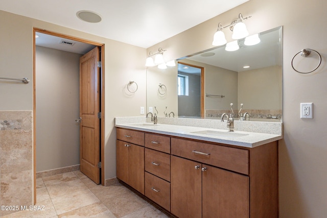 bathroom with tile patterned floors and vanity