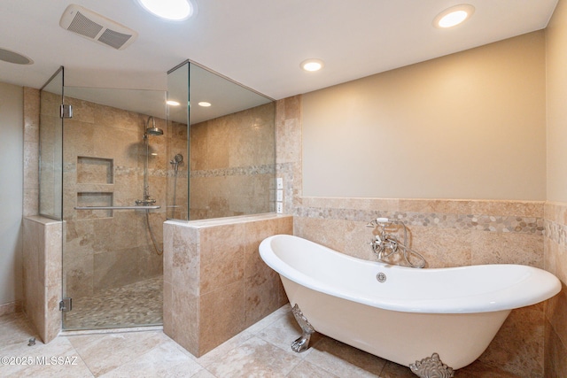 bathroom featuring tile walls, tile patterned floors, and independent shower and bath