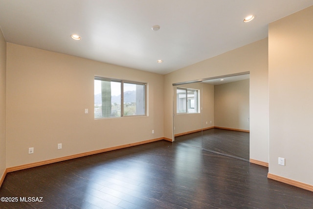 unfurnished room featuring dark hardwood / wood-style flooring