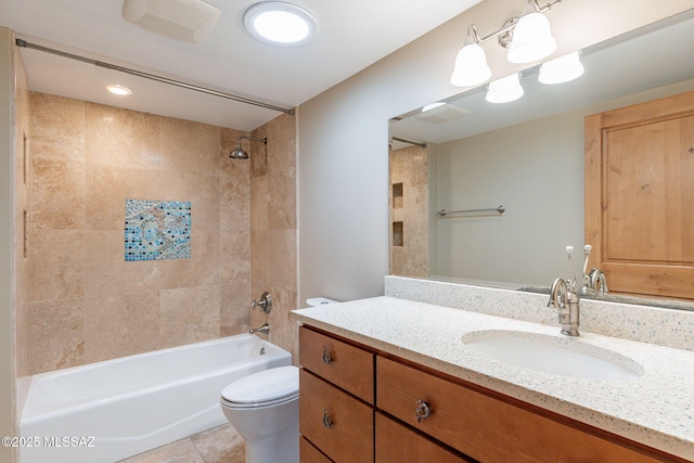 full bathroom featuring tiled shower / bath, tile patterned floors, toilet, and vanity