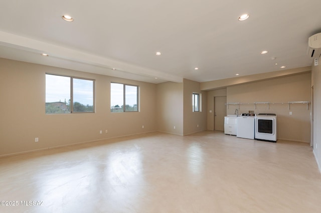 unfurnished living room featuring washer and dryer