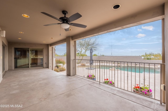 view of patio / terrace with a fenced in pool and ceiling fan