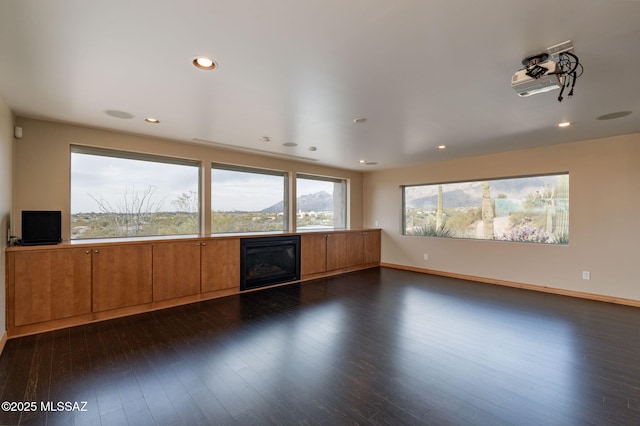 unfurnished living room featuring dark hardwood / wood-style floors