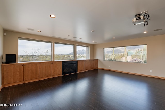 unfurnished living room with dark hardwood / wood-style flooring