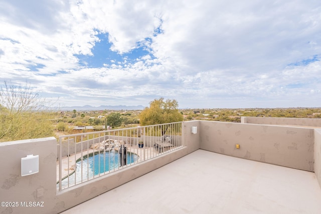 balcony featuring a mountain view and a patio area