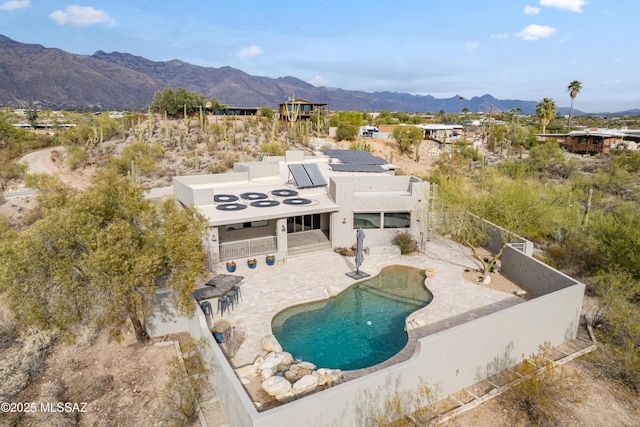 exterior space featuring a mountain view and a patio area