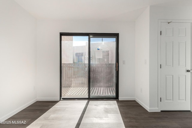 empty room featuring baseboards and wood finished floors