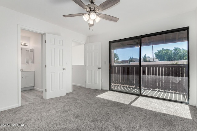 unfurnished bedroom featuring light carpet, access to outside, and ensuite bathroom