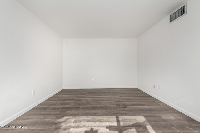 spare room featuring dark hardwood / wood-style floors