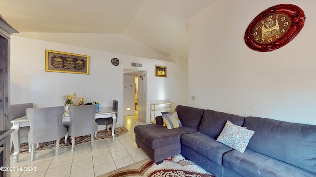 tiled living room featuring vaulted ceiling