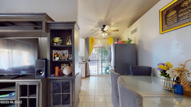 tiled dining area with ceiling fan