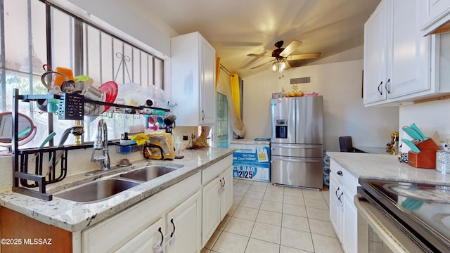 kitchen with white cabinetry, light tile patterned floors, and stainless steel appliances