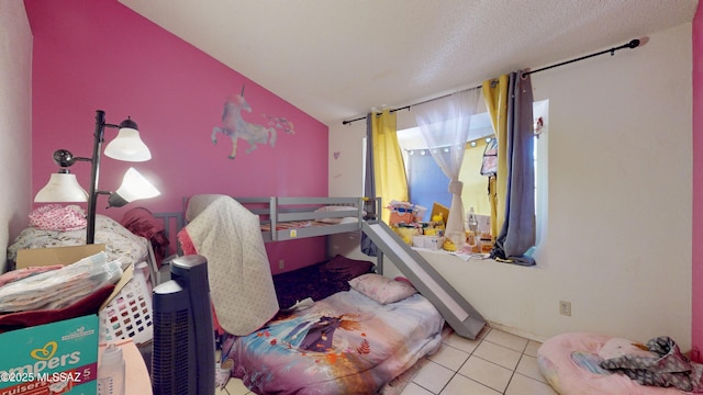 bedroom featuring light tile patterned floors, vaulted ceiling, and a textured ceiling