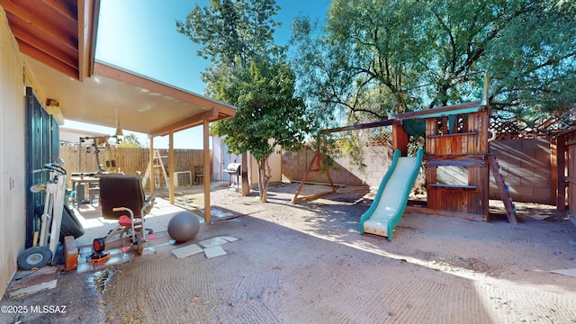 view of playground featuring a patio