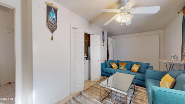 living room with ceiling fan and light tile patterned floors