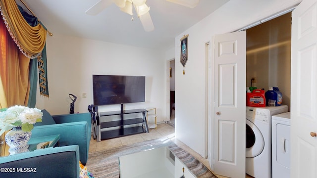 laundry room with ceiling fan, light tile patterned floors, and washing machine and clothes dryer